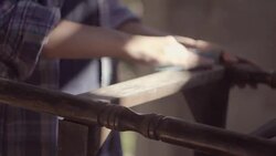 The carpenter girl works in the workshop, restored vintage furniture Stock Footage