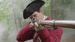 Smoke billowing around Revolutionary War soldier aiming musket Stock Footage