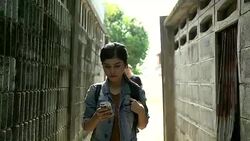 Beautiful young Asian woman talking on mobile phone and being stalked by man criminal on the street. Stock Footage