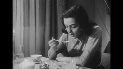 1950s: Wife sits at dinner table and picks at food Stock Footage