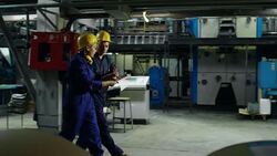 Engineers Discussing Blueprints in Industrial Facility Stock Footage