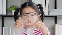 Education Topics:Funny little girl doing experiments in the laboratory.Science and education. Stock Footage