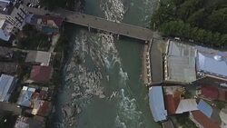 Muddy water flows in rapid Rioni river, Kutaisi city in Georgia, ecology Stock Footage