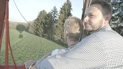 Couple looks out from hot air balloon Stock Footage