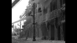 Water sprayed by firemen on Port Chester, NY, fire freezes on buildings, lines, fire truck News Clip
