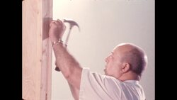 1970s: Man hammers nails into wood Stock Footage