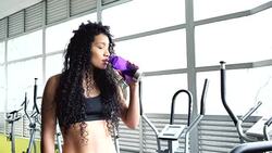 Woman drinking water after exercising Stock Footage