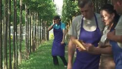 Gardeners look at the tablet and talk Stock Footage