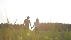 Loving boyfriend and girl hugging on the grass Stock Footage