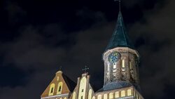 Illumination on a historic building. Historic Landmark. Time lapse. Cathedral of Kant in Kaliningrad. Old medieval at night against the sky. An ancient tower with a clock. Timelapse. Stock Footage