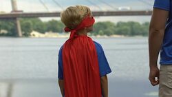 Insecure boy wearing superhero costume finds fathers support, holding hands Stock Footage