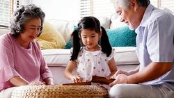Senior man woman and little girl playing board game together at home. people with family, lifestyle, education concept. 4k resolution. Stock Footage
