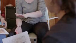 Creative designers meeting, discussing photograph proofs in circle Stock Footage