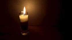 The fire of a burning candle in a narrow glass Stock Footage