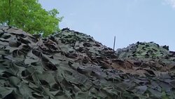 The camouflage cloth with the net cover on the tank Stock Footage
