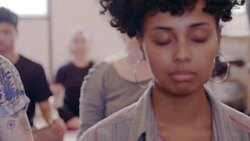 Serene creative businesswoman meditating in office Stock Footage