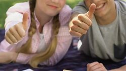 Teenage couple thumbs up, student exchange program, education abroad, success Stock Footage