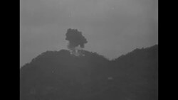 Plane bombs mountain in Korean War action; flames and smoke News Clip