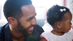 Parents singing and dancing with baby daughter at home - shot in slow motion Stock Footage