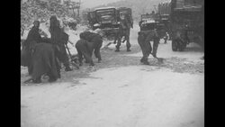 Vehicles slowly travel snow-packed roads in North Korea; soldiers break up ice News Clip