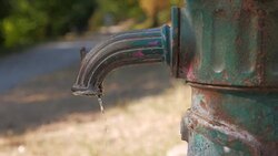 Dripping water from a water tap in a light park. Stock Footage