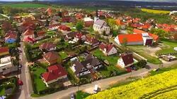 Camera flight over small village Litice suburb of Pilsen. Living in agricultural landscape. Environmentally friendly living. Czech Republic, Europe. Stock Footage