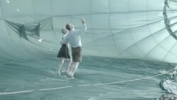 German couple explores inside of partially inflated air balloon Stock Footage