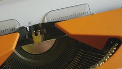 Close up footage of a person writing SYNDROME on an old typewriter, with sound Stock Footage