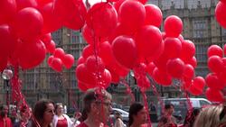 Campaigners hold red balloons outside Parliament to represent children killed in Gaza News Clip