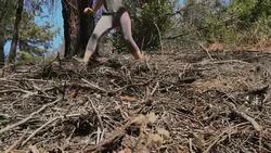 fit woman running down a hill of dirt and branches Stock Footage