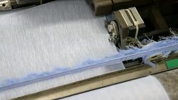 White Threads on a loom in weaving loom machine in textile factory Stock Footage