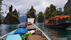 Moving follow boat with Beautiful mountains lake river sky and natural attractions in Ratchaprapha Dam at Khao Sok National Park, Surat Thani Province, Thailand. Stock Footage
