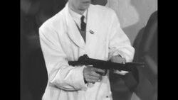 Major Robert Turp demonstrates Sterling machine gun; in sand, mud, cold in Dagenham, London, UK News Clip