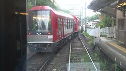 Hakone Tozan Mountain Train Passing Trough Small Stations, Tunnels And Winding Through A Narrow, Densely Wooded Valley In Hakone, Japan Stock Footage