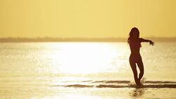 Young Asian Chinese girl on beach at sunset Stock Footage