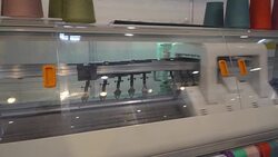 Manufacture of knitwear, modern flat Knitting Machine Stock Footage