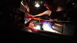Craftsman working on huge old wooden brocade weaving looms Stock Footage