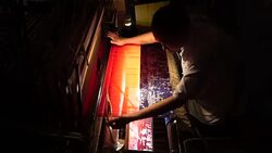 Craftsman working on huge old wooden brocade weaving looms Stock Footage
