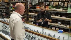 Store manager shows firearrm News Clip