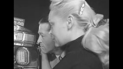 Woman playing slots in casino stops when atom bomb flashes off-screen News Clip