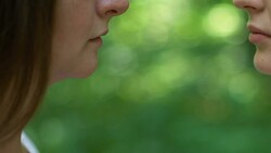 Secret date of lesbian couple, women kissing each other affectionately, closeup Stock Footage