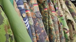 The camouflage uniforms hanging on the cabinet Stock Footage