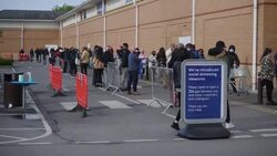 UK: Shoppers socially distancing outside Tesco supermarket in Osterley. News Clip