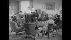 1960s: Woman brings cake into living room meeting Stock Footage