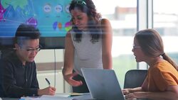 Teacher Standing Over Her Students Helping Them Stock Footage