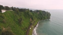 Aerial view of railroad track along seacoast, beautiful nature of Batumi garden Stock Footage