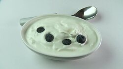 blueberries dropping onto yogurt breakfast Stock Footage