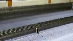 White Threads on a loom in weaving loom machine in textile factory Stock Footage