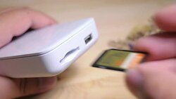 Close-up of a man's hand is plugging a micro sd card into the reader to retrieve the data with soft focus scene. Stock Footage