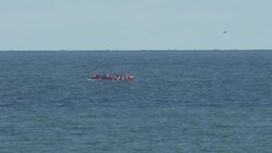 Migrant small boat is shadowed by French rescue vessel off the coast of Dunkirk News Clip